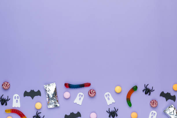 istock Assorted colorful candies over purple background with copy space 2178699798