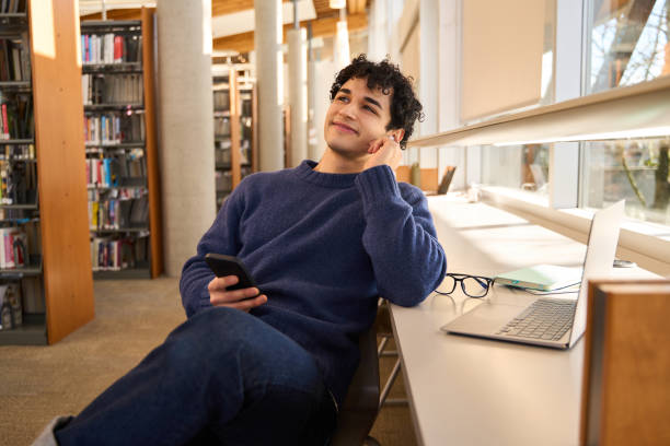 istock Thoughtful student listening to music in university library 2178703022