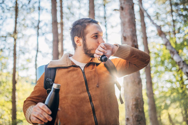 istock Young man connected with forest and drinking water from bottle 2178704731