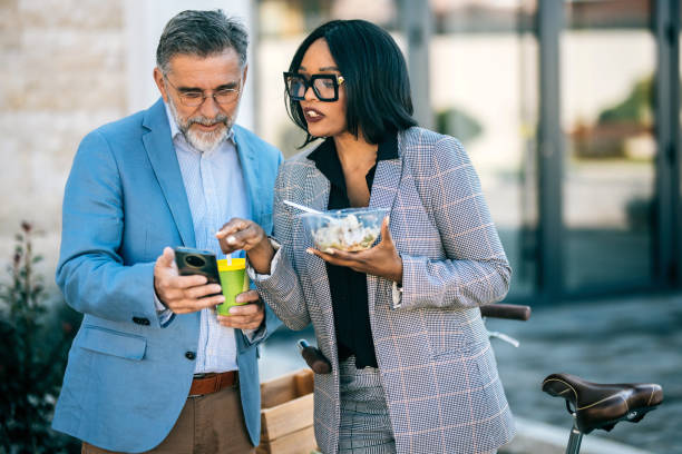 istock Office workers eating lunch together outdoors 2178707694