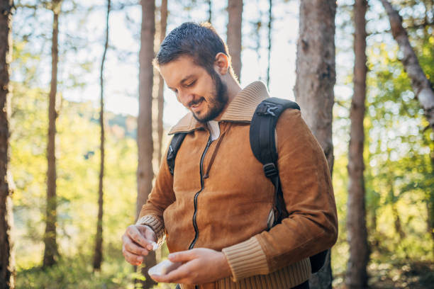 istock Young man connected with forest and putting earbuds 2178707861
