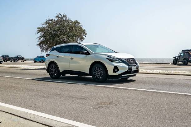 Lisbon, Portugal, July 30, 2025, White nissan micra driving on an asphalt road