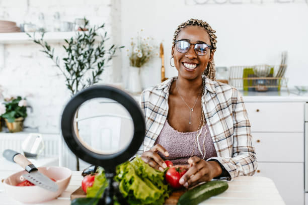 istock Smiling Woman Preparing Fresh Salad With Vegetables in Modern Kitchen 2178711145