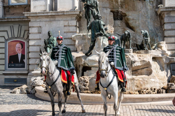 Budapest, Hungary. August 26, 2022. Two guards on horseback in front of the Buda Castle Fountain, the King Matthias Fountain. It represents a break during a hunting trip.