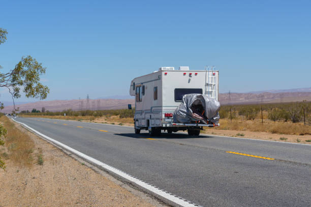 Bulky road transport of mobile prefabricated homes, oversized vehicle. Rear view.