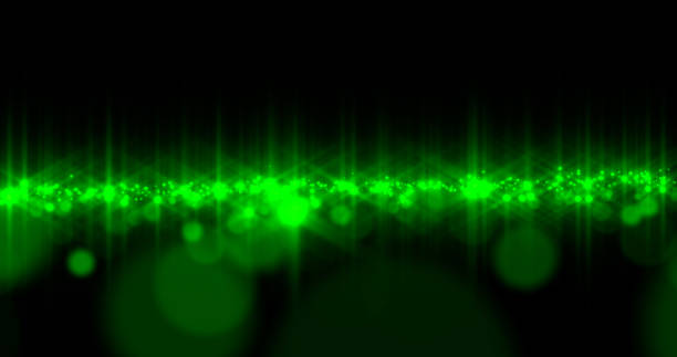Bright glowing particles, a field of green dust on a black space. Beautiful backdrop for text, background. High quality photo