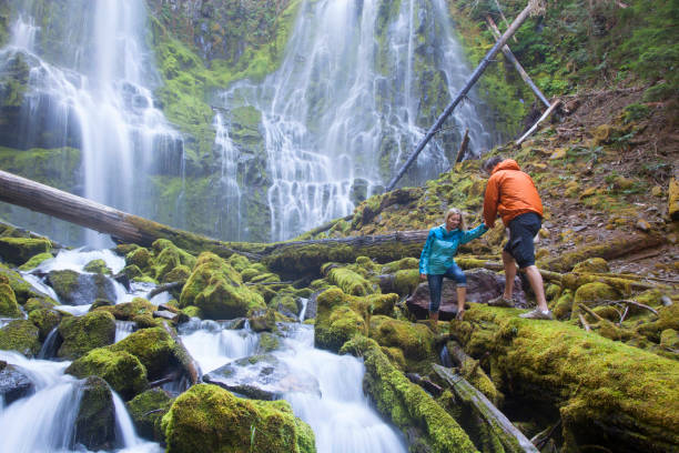 young couple hiking near falls