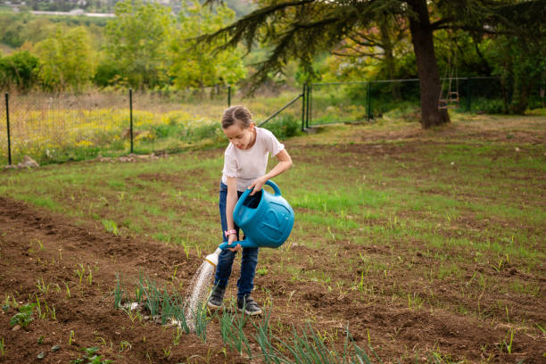 istock Girl watering garden at spring 2178720897