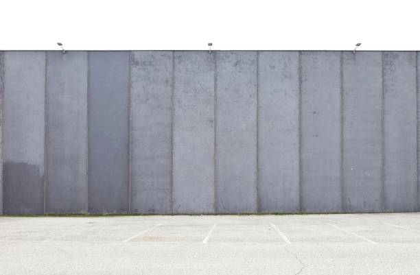 istock Grunge massive prefab concrete wall with street in front 2178725005