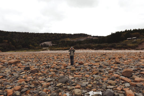 istock Man Walking Along Seabed During Low Tide 2178725534