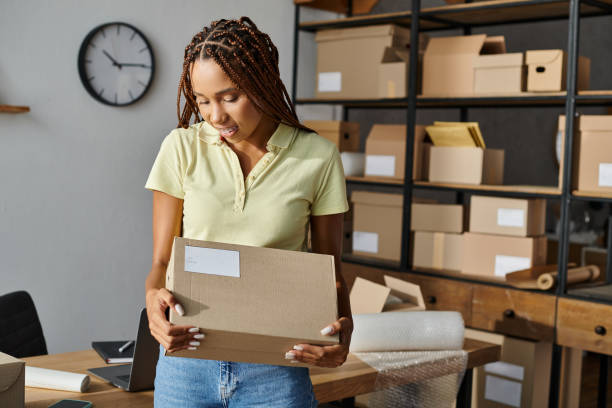 istock Young woman preparing packages for delivery at a busy post office during work hours 2178726348