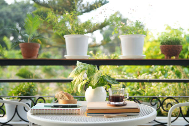istock coffee glass cup with notebooks on white metal table outdoor balcony 2178728535