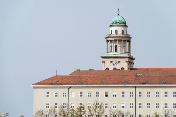 A detailed view of the Benedictine Pannonhalma Archabbey’s dome and clock tower, rising above the red-tiled roof of the historic monastery. The architectural details of the clock and dome highlight the abbey’s significance as a cultural and religious landmark in Hungary.