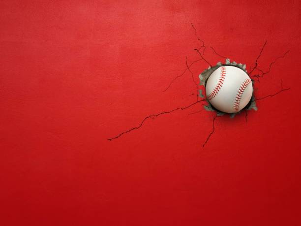 istock Baseball breaks through red concrete wall concept of power, strength. 2178731195