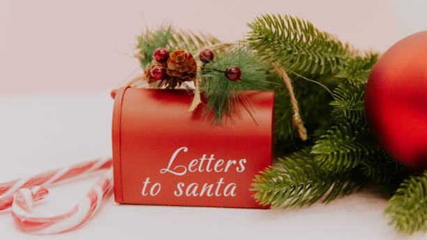 istock Santa Claus mailbox with fir branches and Christmas decor on light pink. 2178731634