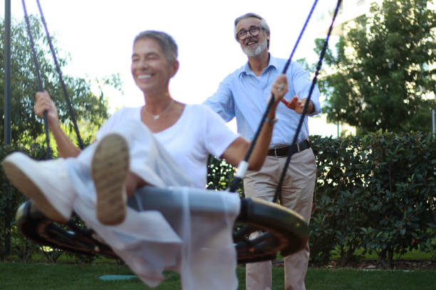 istock Happy senior couple enjoy swing park 2178733767