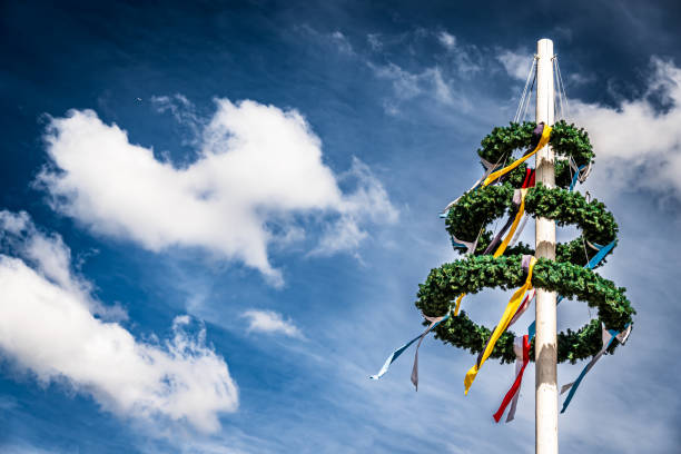 typical bavarian maypole in front of blue sky - photo