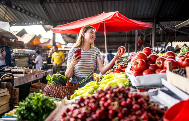 istock Woman choosing tomatoes 2178738125