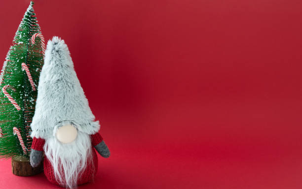 istock A gnome is standing in front of a Christmas tree 2178740266