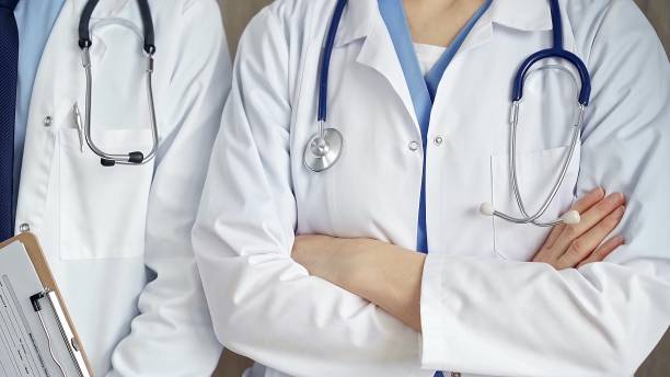 istock Professional healthcare team in uniform. Two doctors with stethoscopes are standing straight with arms crossed. Medicine concept 2178741027