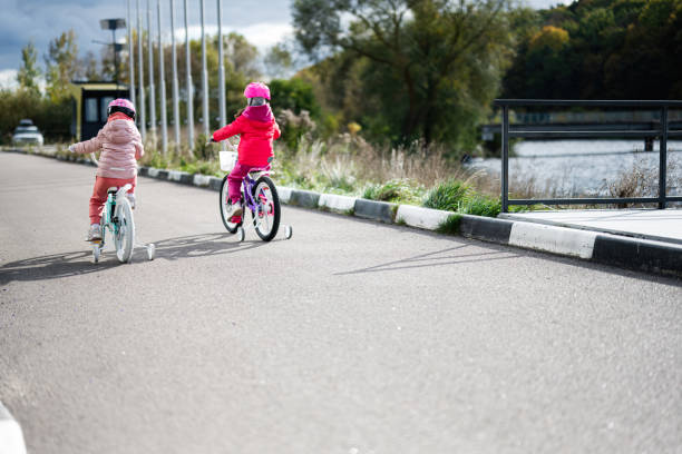 istock Two young children riding bicycles on a sunny autumn day 2178741185