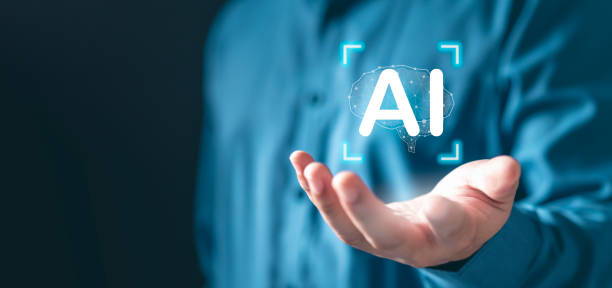 istock A man is holding a hand up with the word AI on it. Concept of artificial intelligence. 2178741396
