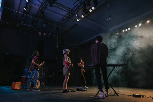 istock Young Asian chinese lead singer and live band Multiracial group performance on stage 2178742690