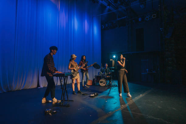 istock Young Asian chinese lead singer and live band Multiracial group performance on stage 2178742702
