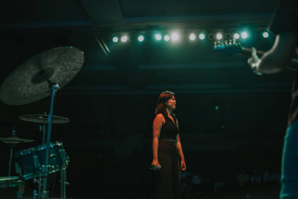 istock Young Asian chinese lead singer  on stage with dark background 2178742725