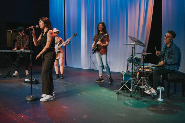 istock Young Asian chinese lead singer and live band Multiracial group performance on stage 2178742779