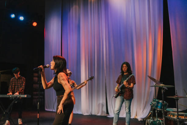 istock Young Asian chinese lead singer and live band Multiracial group performance on stage 2178742780