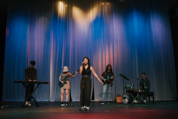 istock Young Asian chinese lead singer and live band Multiracial group performance on stage 2178742793