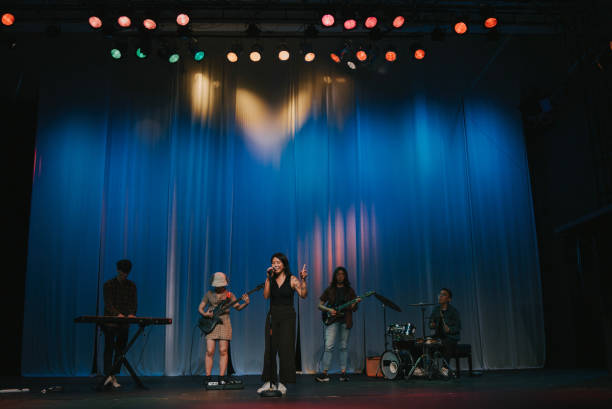 istock Young Asian chinese lead singer and live band Multiracial group performance on stage 2178742800