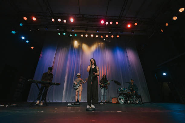 istock Young Asian chinese lead singer and live band Multiracial group performance on stage 2178742816