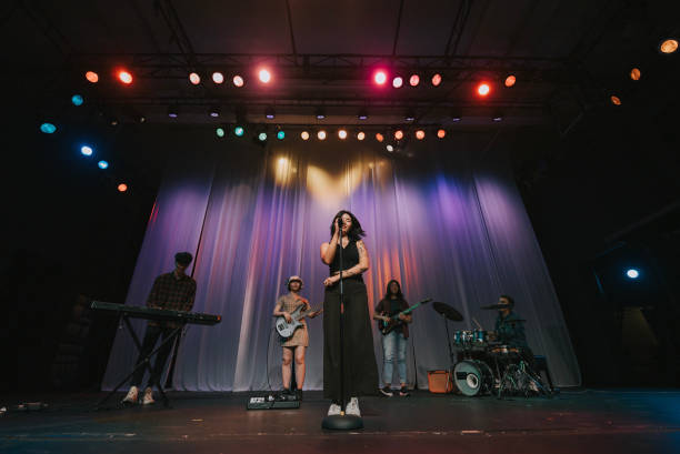 istock Young Asian chinese lead singer and live band Multiracial group performance on stage 2178742831