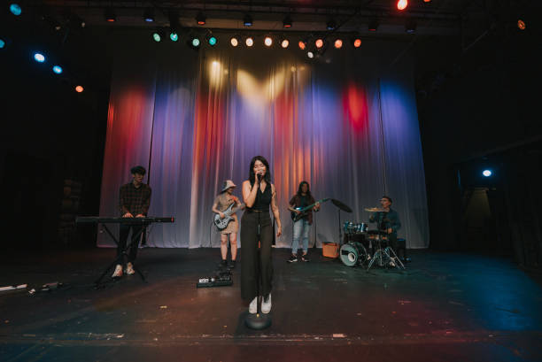 istock Young Asian chinese lead singer and live band Multiracial group performance on stage 2178742845