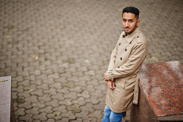 Stylish kuwaiti man at trench coat.