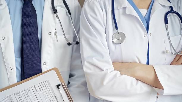 istock Professional healthcare team in uniform. Two doctors with stethoscopes are standing straight with arms crossed. Medicine concept 2178746877