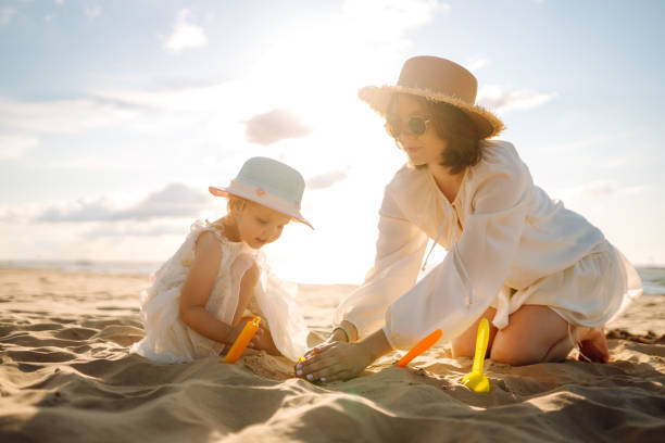 istock Mother and daughter enjoying time at the beach. 2178747680