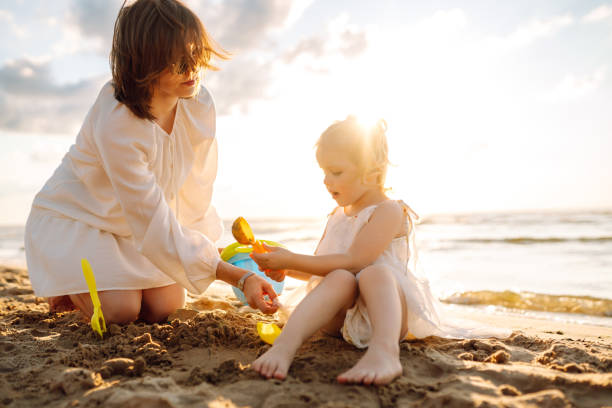 istock Mother and daughter enjoying time at the beach. 2178747700