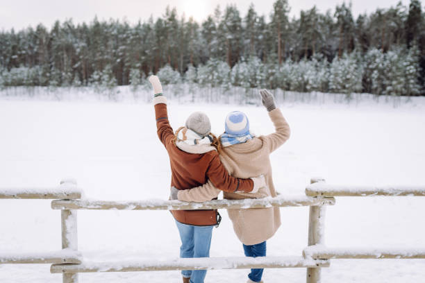istock Happy friends having fun playing in winter park. 2178749774