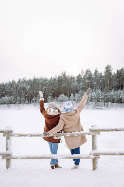 Happy friends having fun playing in winter park.