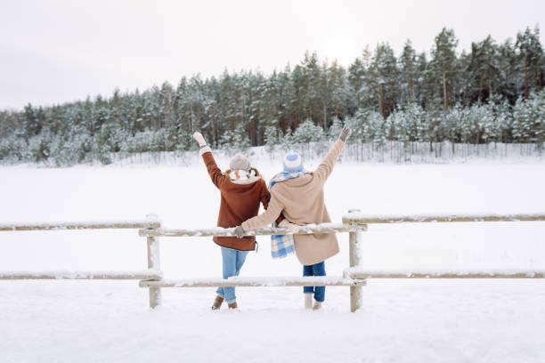 istock Happy friends having fun playing in winter park. 2178749778