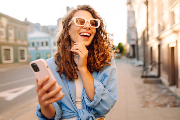 istock Young woman walking around old street and using smartphone. 2178750034