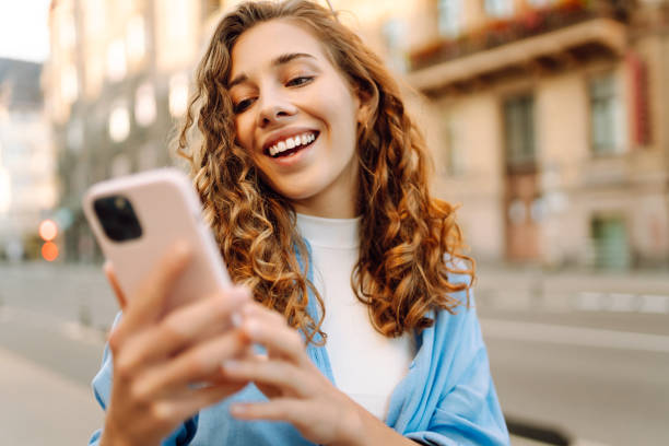 istock Young woman walking around old street and using smartphone. 2178750055
