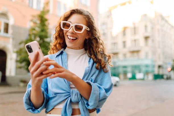 istock Young woman walking around old street and using smartphone. 2178750064