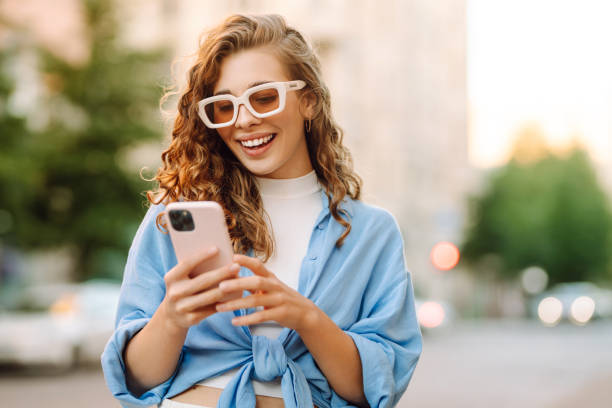 istock Young woman walking around old street and using smartphone. 2178750077
