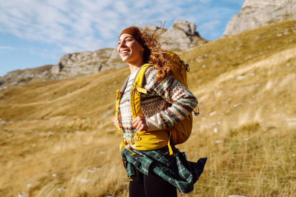 istock Young woman backpacker on mountains cliff hiking enjoy landscape. 2178750531