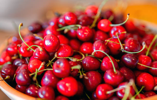 istock Pile of ripe red cherries with stalks. 2178752135