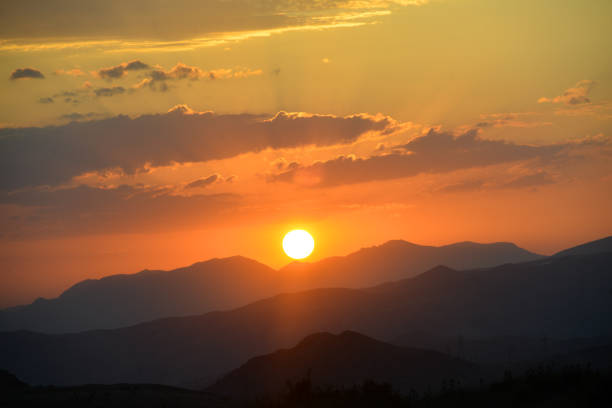 The Beautiful sunset over the mountains in the summer.